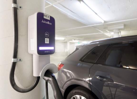 A car is being charged at charging station.