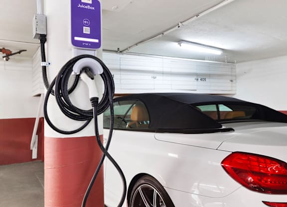 A vehicle being charged at a charging station.