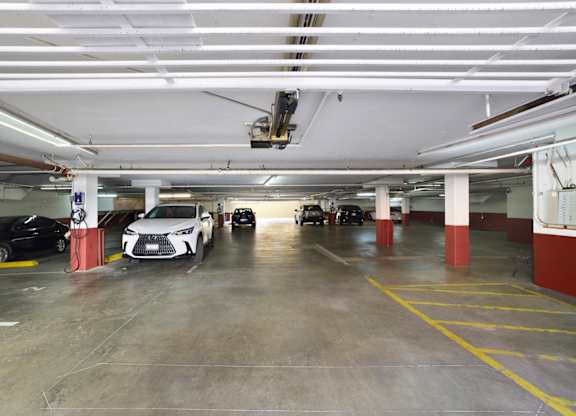 A parking garage with parked vehicles.