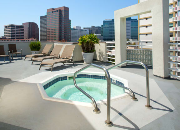 Roof terrace with hot tub, lounge furniture and city views