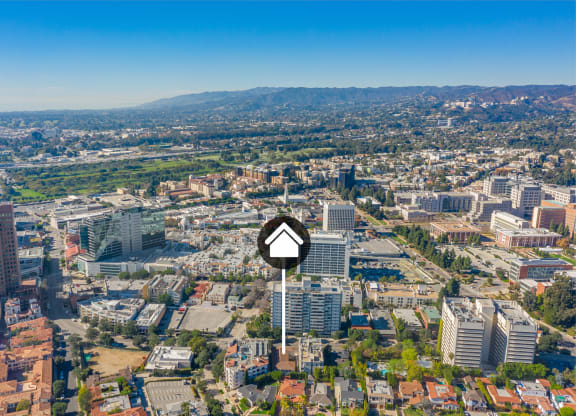 Aerial view of buildings and homes with property identification marker