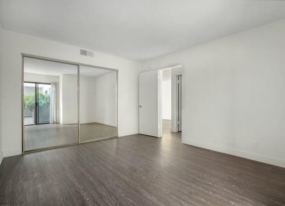 Apartment bedroom with mirrored closet doors
