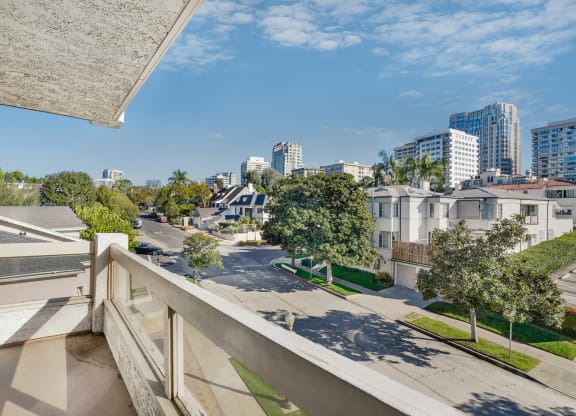 Apartment balcony with street and treetop views