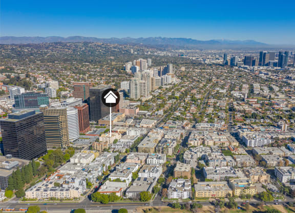 Aerial view of buildings and homes with property identification marker