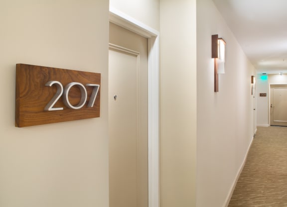 Apartment interior corridor with unit identification sign