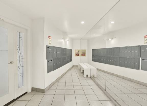 Lobby with mailboxes, a mirror and a bench