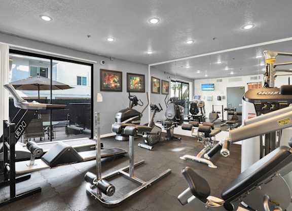 A gym with a variety of equipment and cardio machines at Park Rochester, Los Angeles