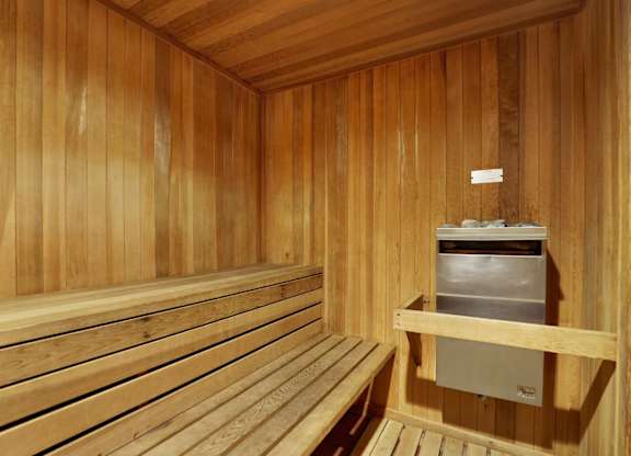 A wooden sauna with benches and a heater at Midvale Towers, California