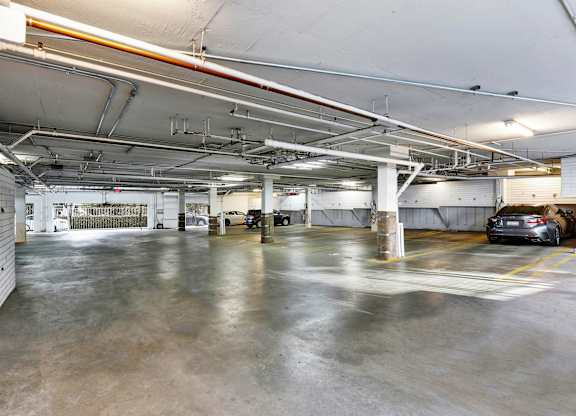 A spacious garage with concrete floors and multiple parking spaces at Peach Tree Court, Los Angeles, CA 90024