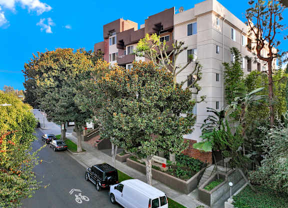 A white van is parked on the side of a street at Peach Tree Court, Los Angeles