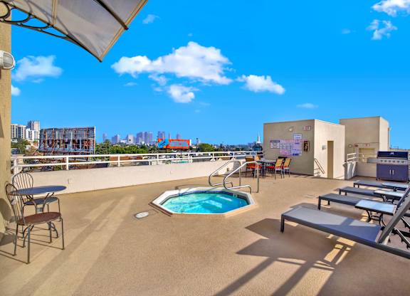 A pool on a patio with chairs and a table at Peach Tree Court, Los Angeles, California