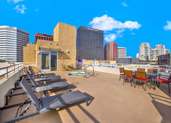 A rooftop patio with chairs and a table at Peach Tree Court, Los Angeles