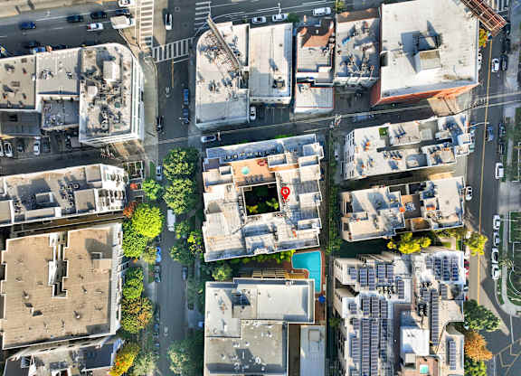 A bird's eye view of a city street with buildings, cars, and trees at Peach Tree Court, California