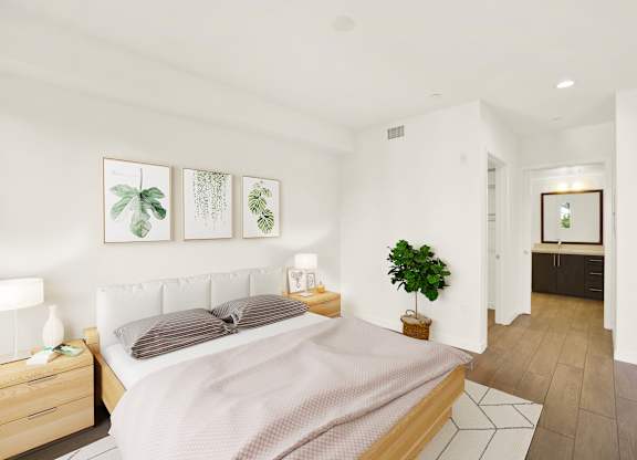 A bedroom with a bed, nightstand, and a plant at The Urbanpolitan, California