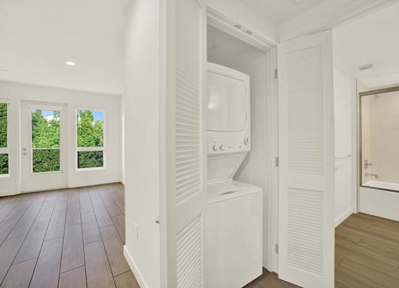 A white bathroom with a toilet and sink at The Urbanpolitan, Los Angeles, CA