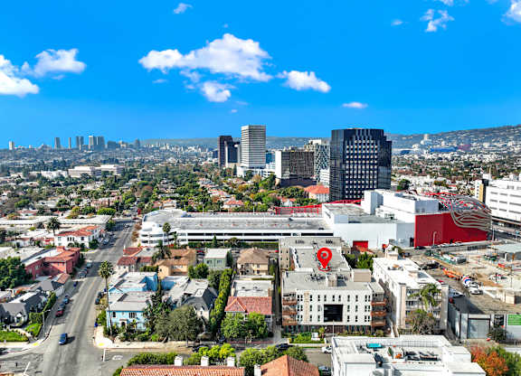 A cityscape with a mix of residential and commercial buildings under a clear blue sky at The Urbanpolitan, Los Angeles