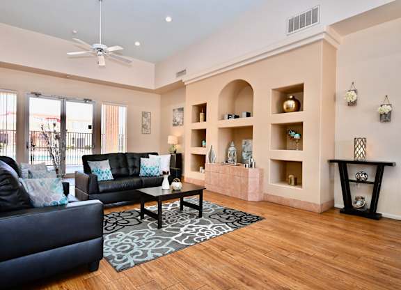 A living room with a black couch and a coffee table.