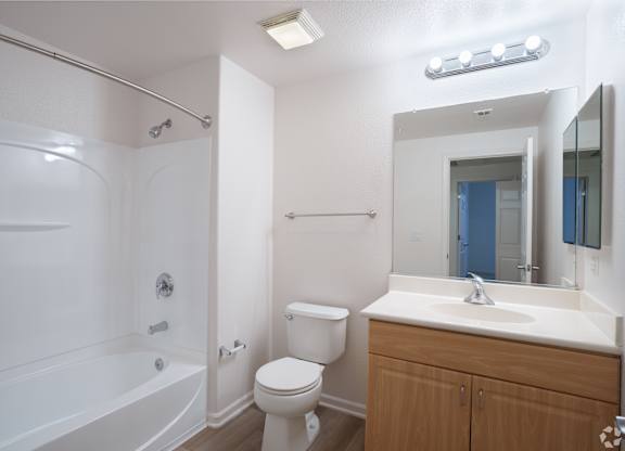 A white bathroom with a toilet, sink, and bathtub at Cornerstone at Gale Ranch Apartments, California, 94582