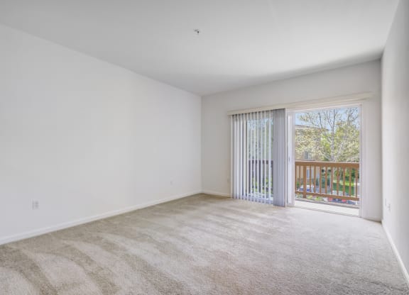 a bedroom with a sliding glass door and a carpeted floor at Cornerstone at Gale Ranch Apartments, San Ramon 94582
