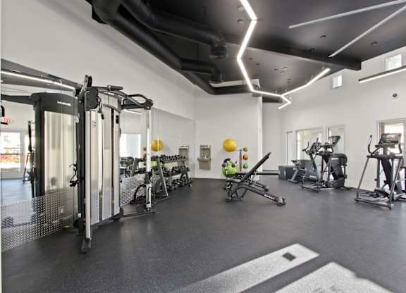 A gym with a variety of exercise equipment.