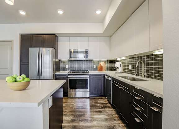 A modern kitchen with stainless steel appliances at Montecito at Carlsbad, Carlsbad, CA 92010