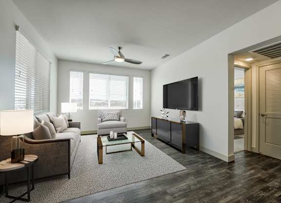 A living room with a couch, a coffee table, and a television at Montecito at Carlsbad, Carlsbad, CA 92010
