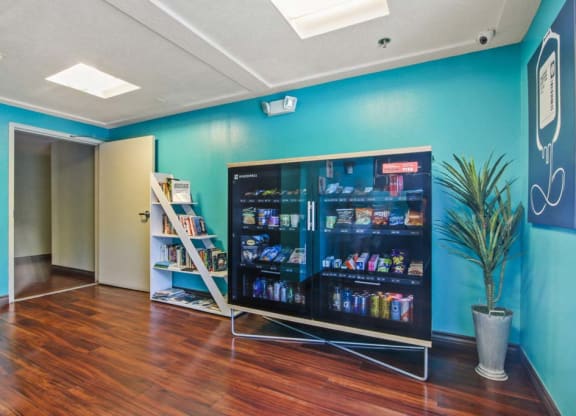 a room with a large screen tv and a bookshelf  at Masselin Park West, Los Angeles