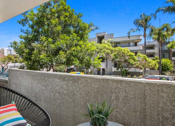 a patio with two chairs and a table at Masselin Park West, Los Angeles, CA