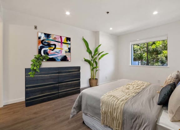 a bedroom with a bed and a dresser in front of a window  at Masselin Park West, Los Angeles, 90036