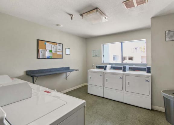 a washer and dryer are in a room with a window  at Masselin Park West, Los Angeles, 90036