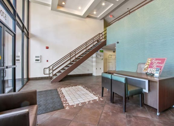 a table and chairs in the lobby of a building  at Masselin Park West, Los Angeles, 90036