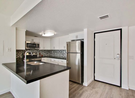 a kitchen with a refrigerator freezer and a sink  at Masselin Park West, California, 90036