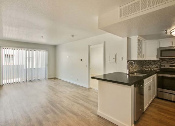 a kitchen and living room with a large window  at Masselin Park West, Los Angeles, CA