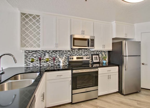 a kitchen with a stove top oven next to a refrigerator  at Masselin Park West, California, 90036