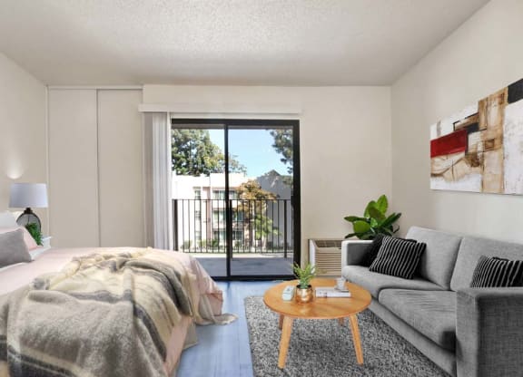 a bedroom with a bed and a couch in front of a sliding glass door  at Sherway Villa, Reseda, California