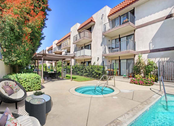a swimming pool in front of an apartment building  at Sherway Villa, Reseda, CA