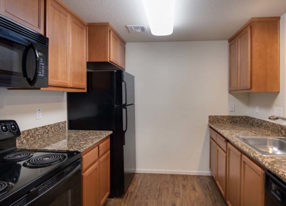 Kitchen with wooden cabinets at Meadow Wood at Alamo Creek, California