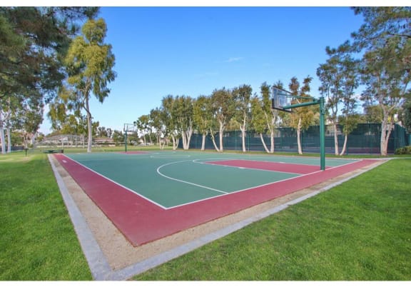 Basketball court is located in the middle of the park  at Harvard Manor, Irvine, 92612