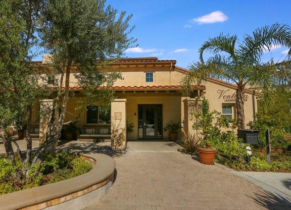 a building with a porch and trees in front of it at Ventana Senior Apartments, California, 91326