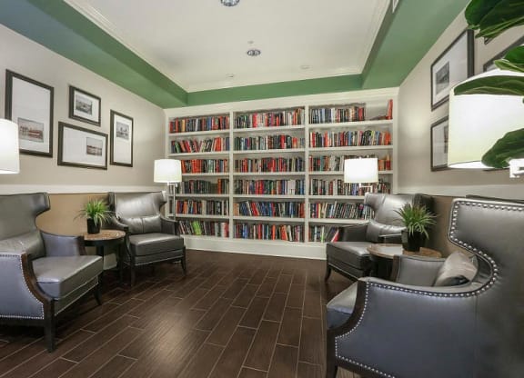 a living room filled with furniture and a large book shelf  at Ventana Senior Apartments, California, 91326