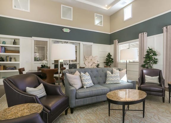 a living room with a couch chairs and tables at Ventana Senior Apartments, California, 91326