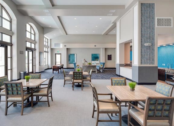 a large community room with tables and chairs and games at Deer Creek Apartments, San Ramon, 94582