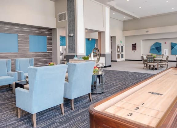 a room with a shuffleboard table and blue chairs  at Deer Creek Apartments, San Ramon, 94582