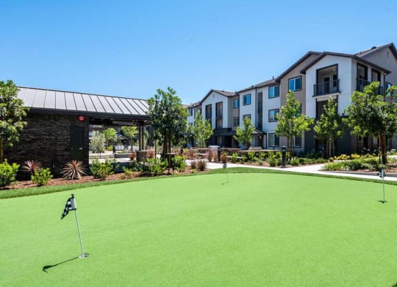 a putting green in front of a building  at The Vineyards Apartments, California, 91326