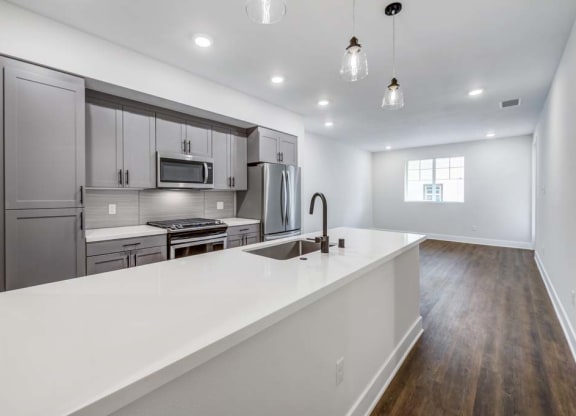a kitchen with a sink and a stove in a house  at The Vineyards Apartments, California, 91326