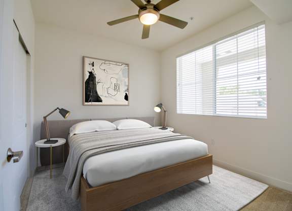 Bedroom with ceiling fan at Portola Senior Apartments, Carlsbad, CA