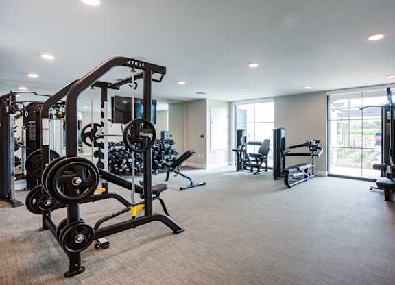 A well-equipped gym with a variety of machines and weights at Pradera Apartments, San Ramon, 94582