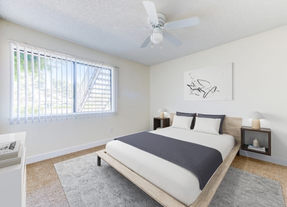 a bedroom with a bed and a ceiling fan at Redlands Park Apts, California