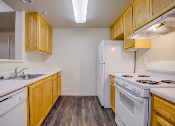 a kitchen with white appliances and wooden cabinets  at Seville at Gale Ranch, San Ramon, California