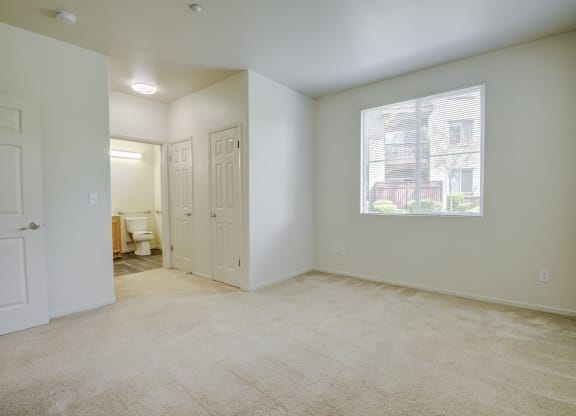 a bedroom with a large window and carpeting  at Seville at Gale Ranch, California, 94582